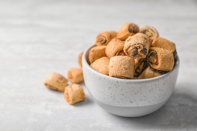 Photo of Tasty sweet cookies with poppy seeds on gray table. Space for text