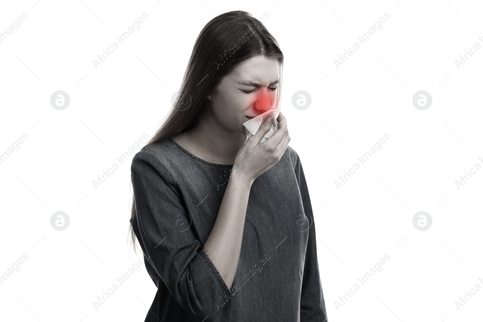 Image of Young woman with tissue sneezing on light background, toned in black and white. Runny nose