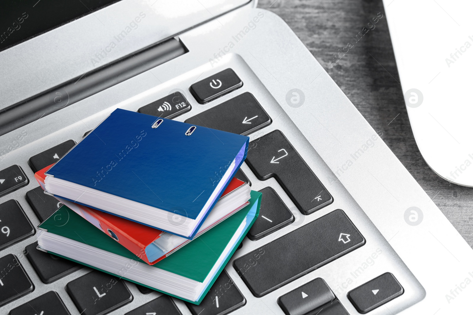 Image of Digital archive. Laptop keyboard with stacked downsized folders on table, closeup