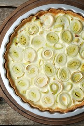 Photo of Freshly baked leek pie on old wooden table, top view