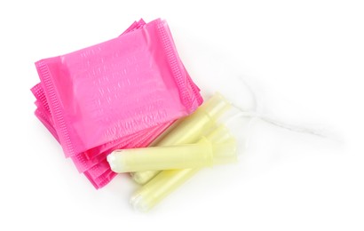 Pads and tampons on white background, top view. Menstrual hygiene product