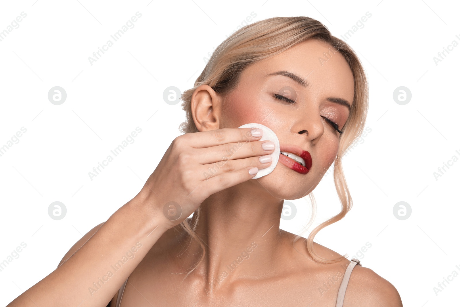 Photo of Beautiful woman removing makeup with cotton pad on white background