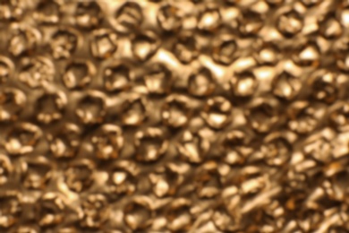 Photo of Blurred view of golden bubble wrap as background