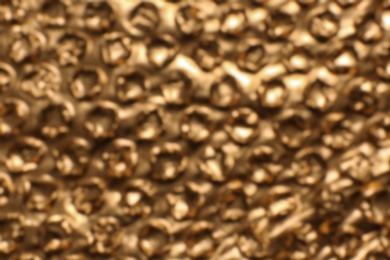 Blurred view of golden bubble wrap as background