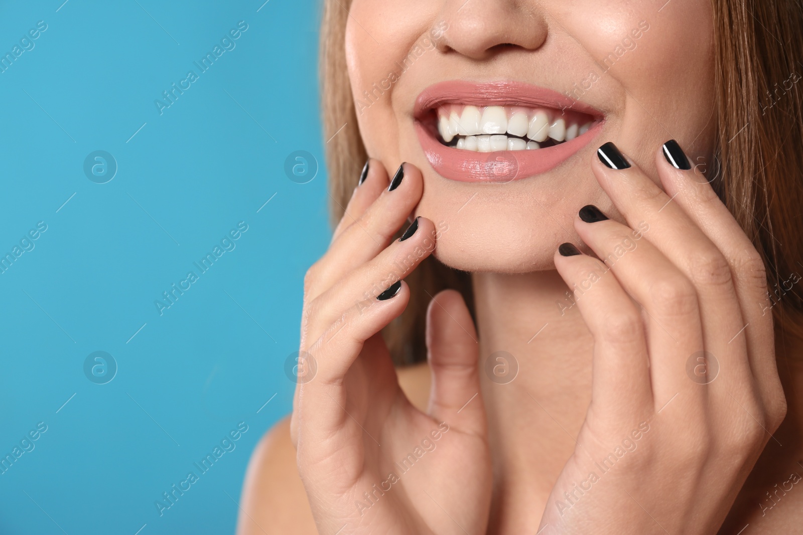 Photo of Beautiful woman with stylish nail polish on color background, closeup. Space for text
