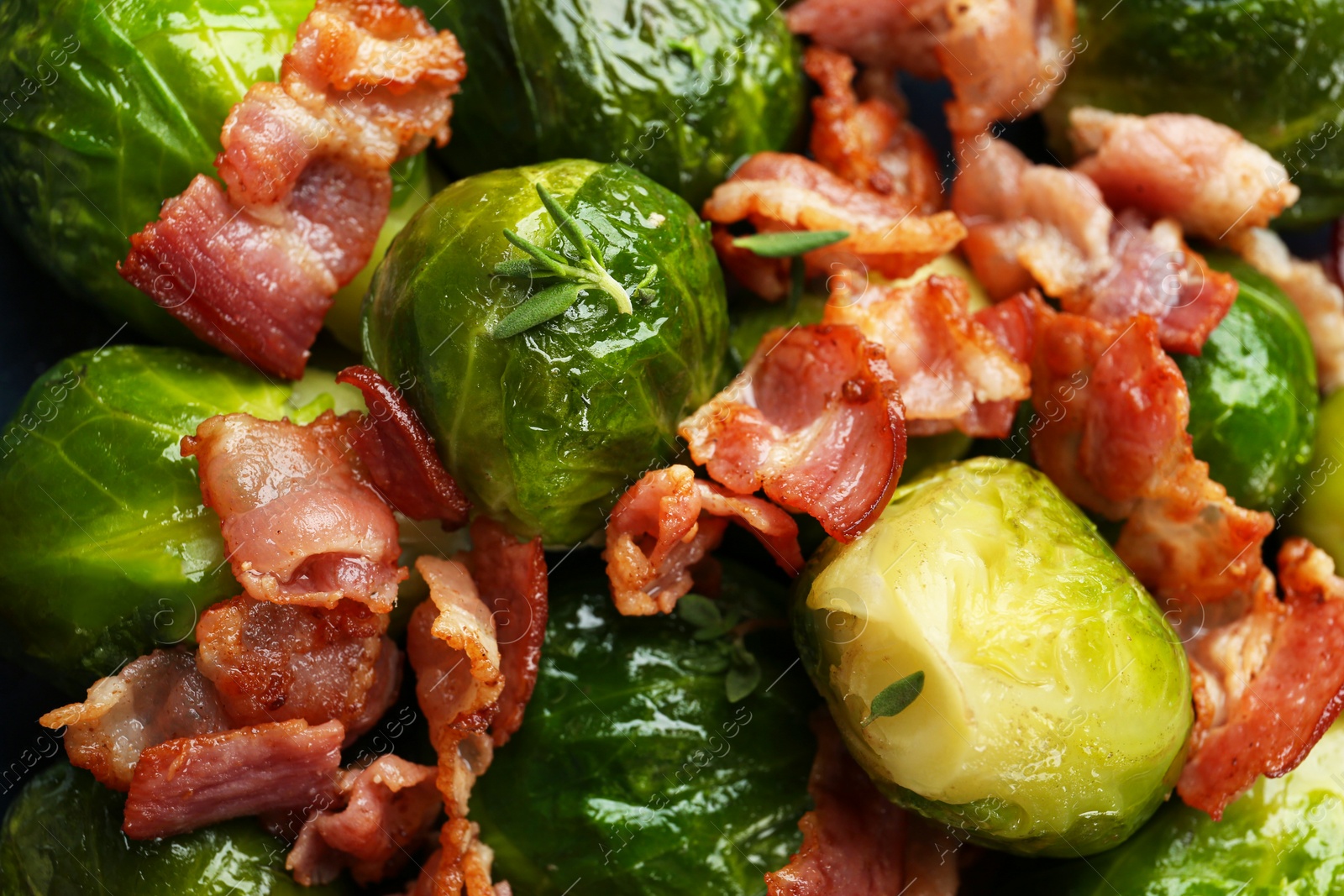 Photo of Tasty cooked Brussels sprouts with bacon as background, closeup