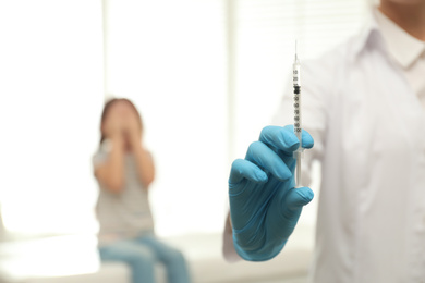 Photo of Doctor with syringe in clinic, closeup. Vaccination day