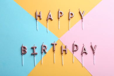 Photo of Flat lay composition with birthday candles on color background