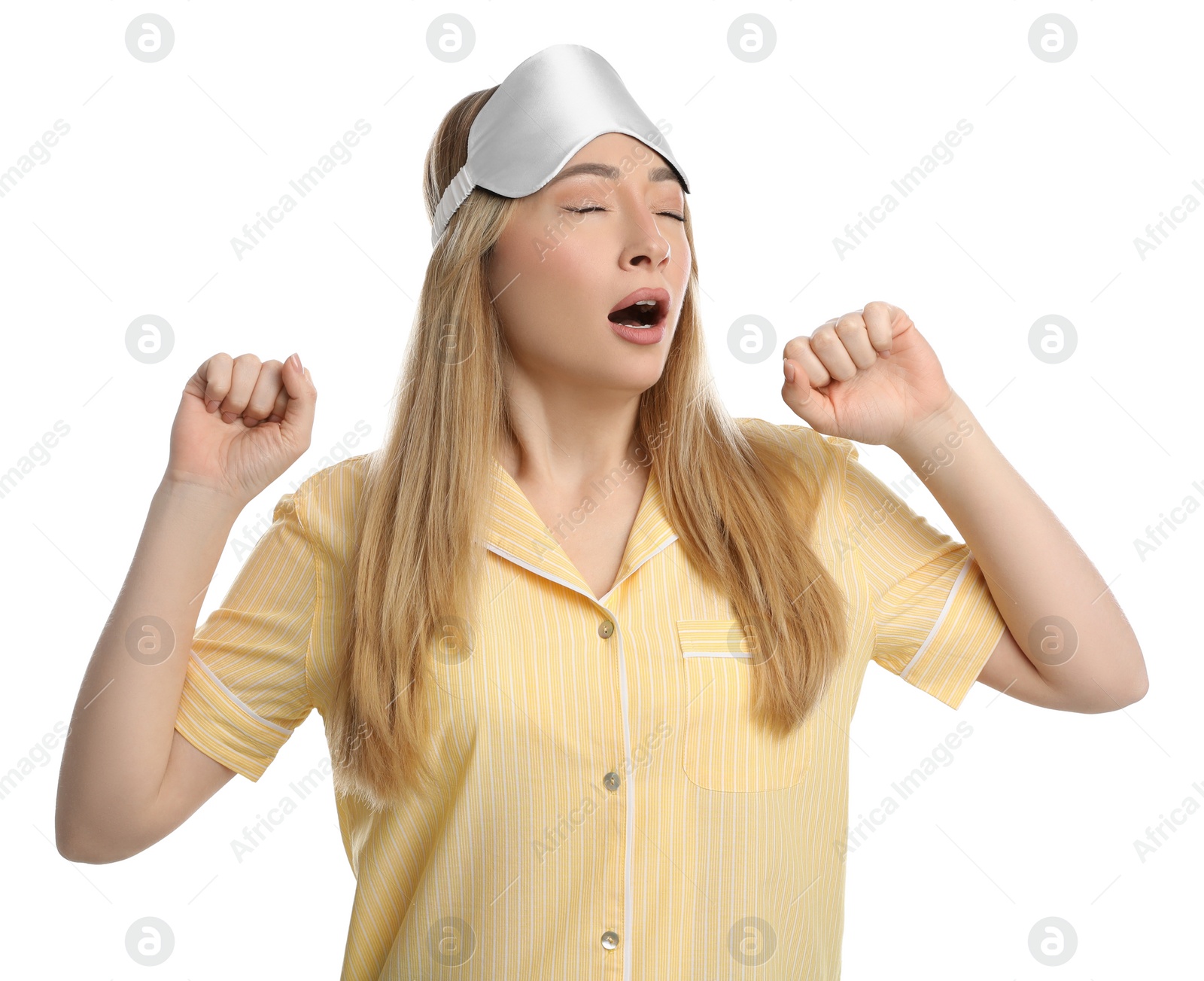 Photo of Young tired woman with sleeping mask yawning on white background