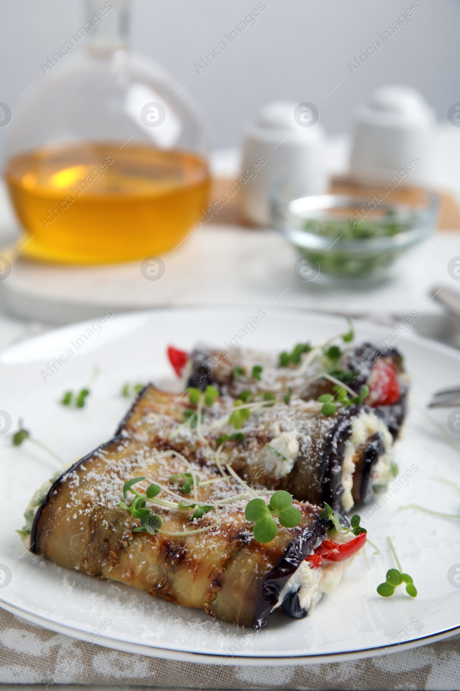 Photo of Delicious baked eggplant rolls served on table, closeup