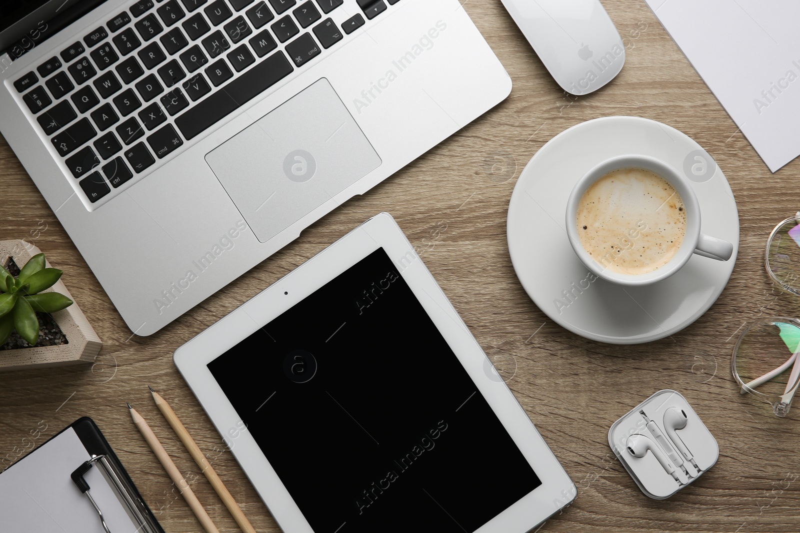 Photo of MYKOLAIV, UKRAINE - JULY 20, 2020: Flat lay composition with different Apple gadgets on wooden table