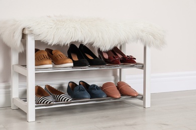 Photo of Rack with different stylish shoes indoors. Idea for interior design