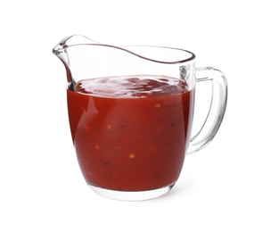 Photo of Glass jug with red sauce on white background