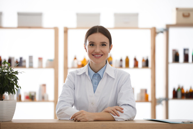 Photo of Portrait of happy female pharmacist in drugstore