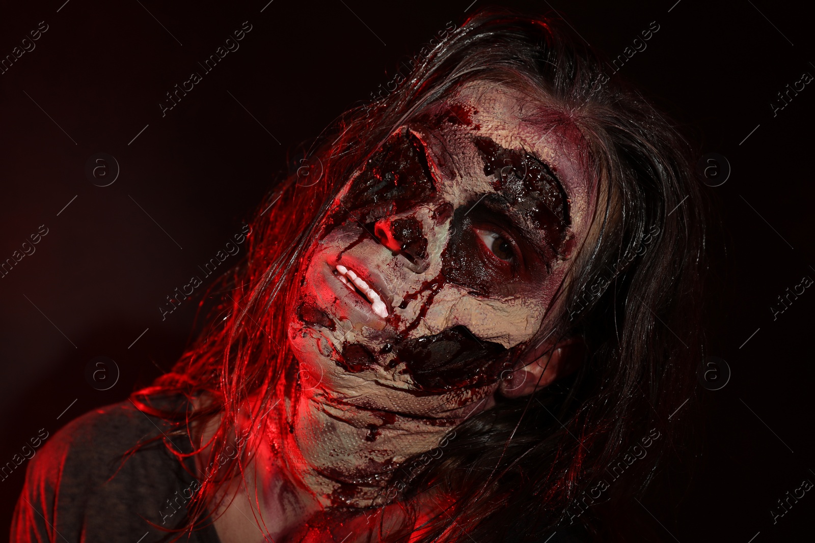 Photo of Scary zombie on dark background, closeup. Halloween monster