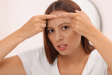 Photo of Woman with skin problem indoors, view from mirror