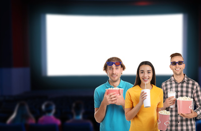 People with 3D glasses, beverage and popcorn in cinema, space for text