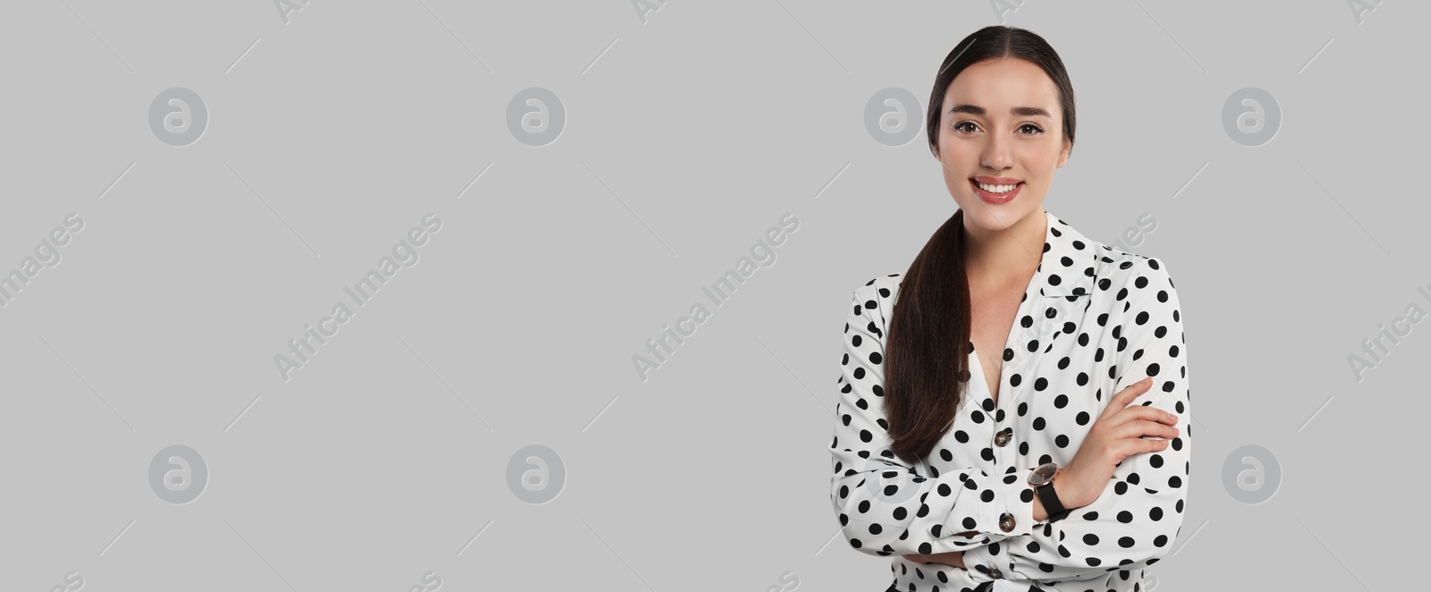 Image of Portrait of beautiful young woman on light grey background. Banner design with space for text