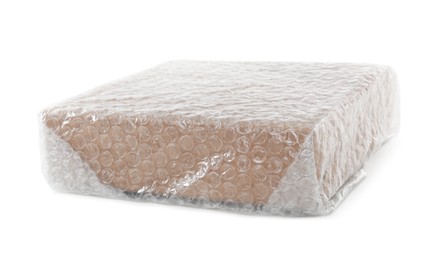 Cardboard box packed in bubble wrap isolated on white