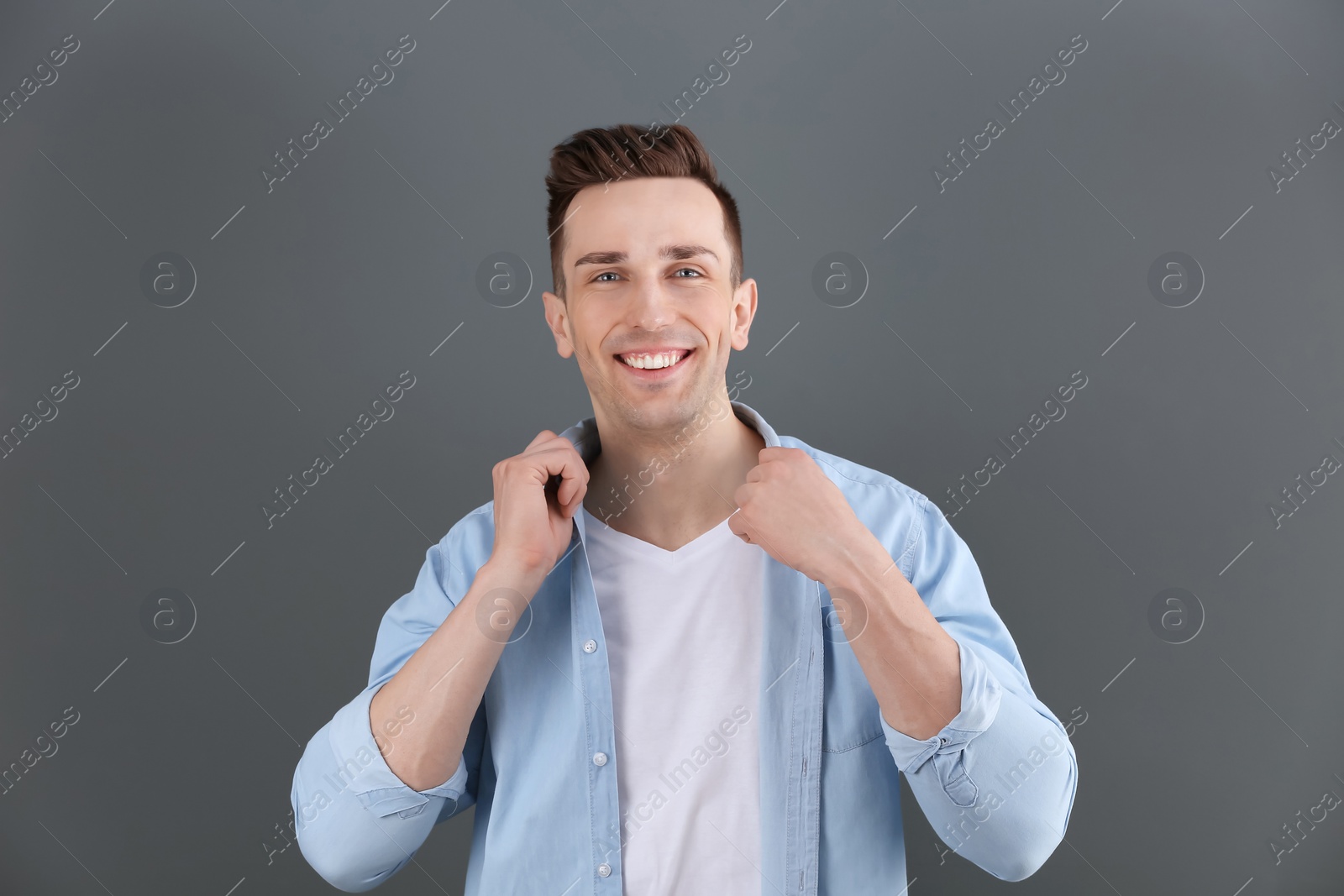 Photo of Charming young man on grey background