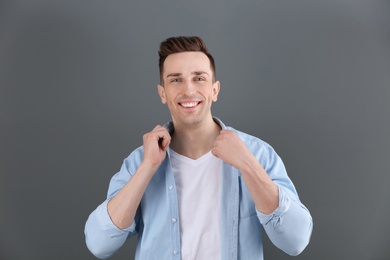 Photo of Charming young man on grey background