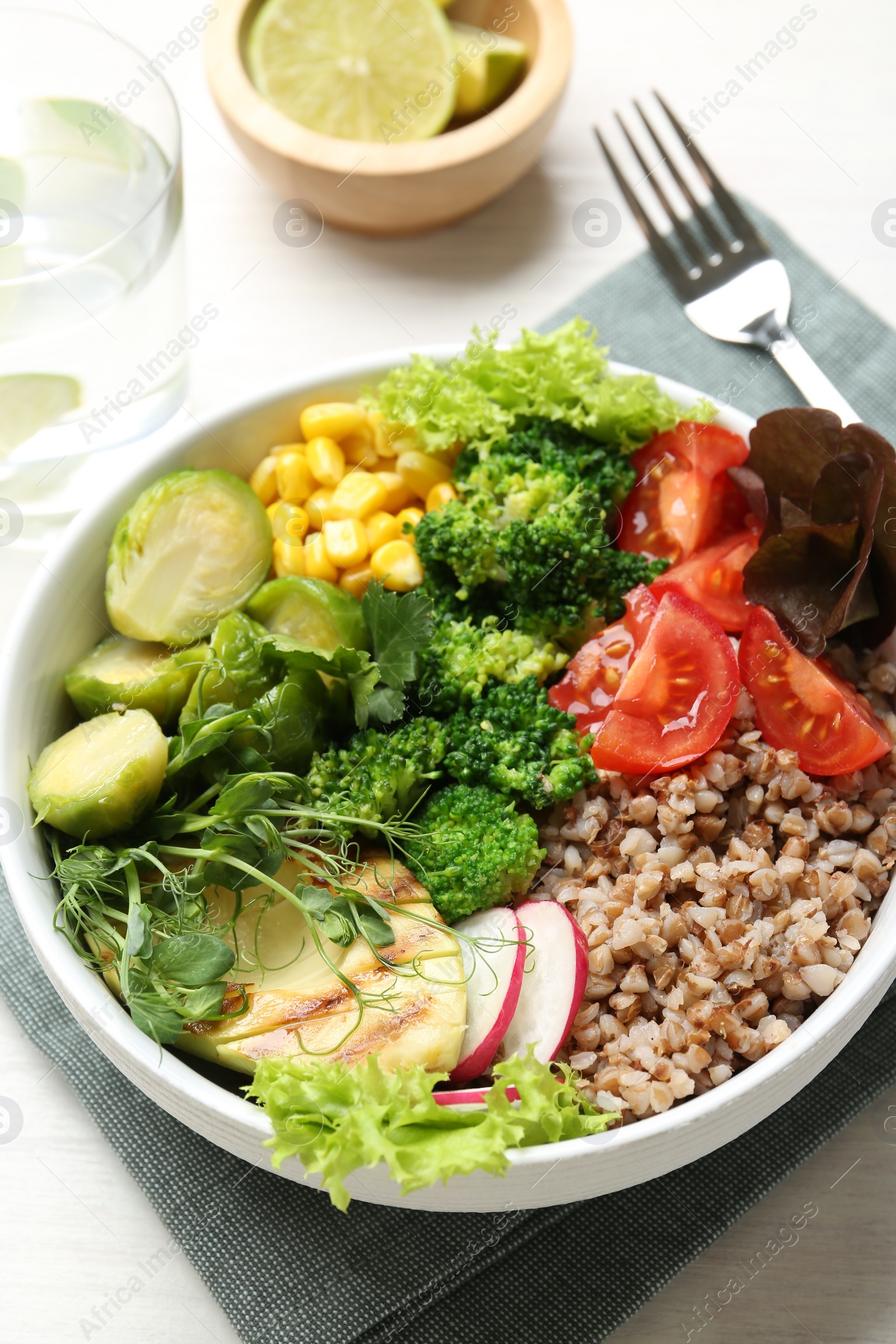 Photo of Healthy meal. Tasty products in bowl on white table, closeup