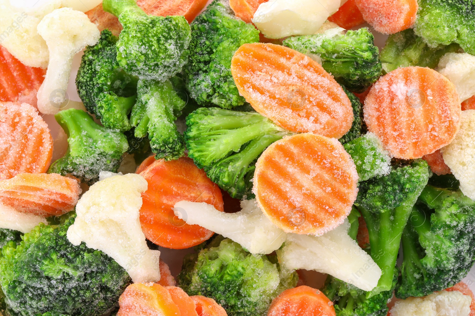 Photo of Mix of different frozen vegetables as background, top view