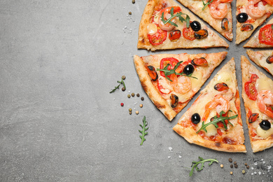 Tasty pizza with seafood and ingredients on grey table, flat lay. Space for text