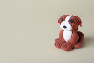 Small dog made from play dough on light grey background. Space for text