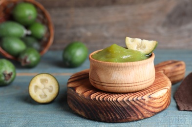 Feijoa jam and fresh fruit on light blue wooden table