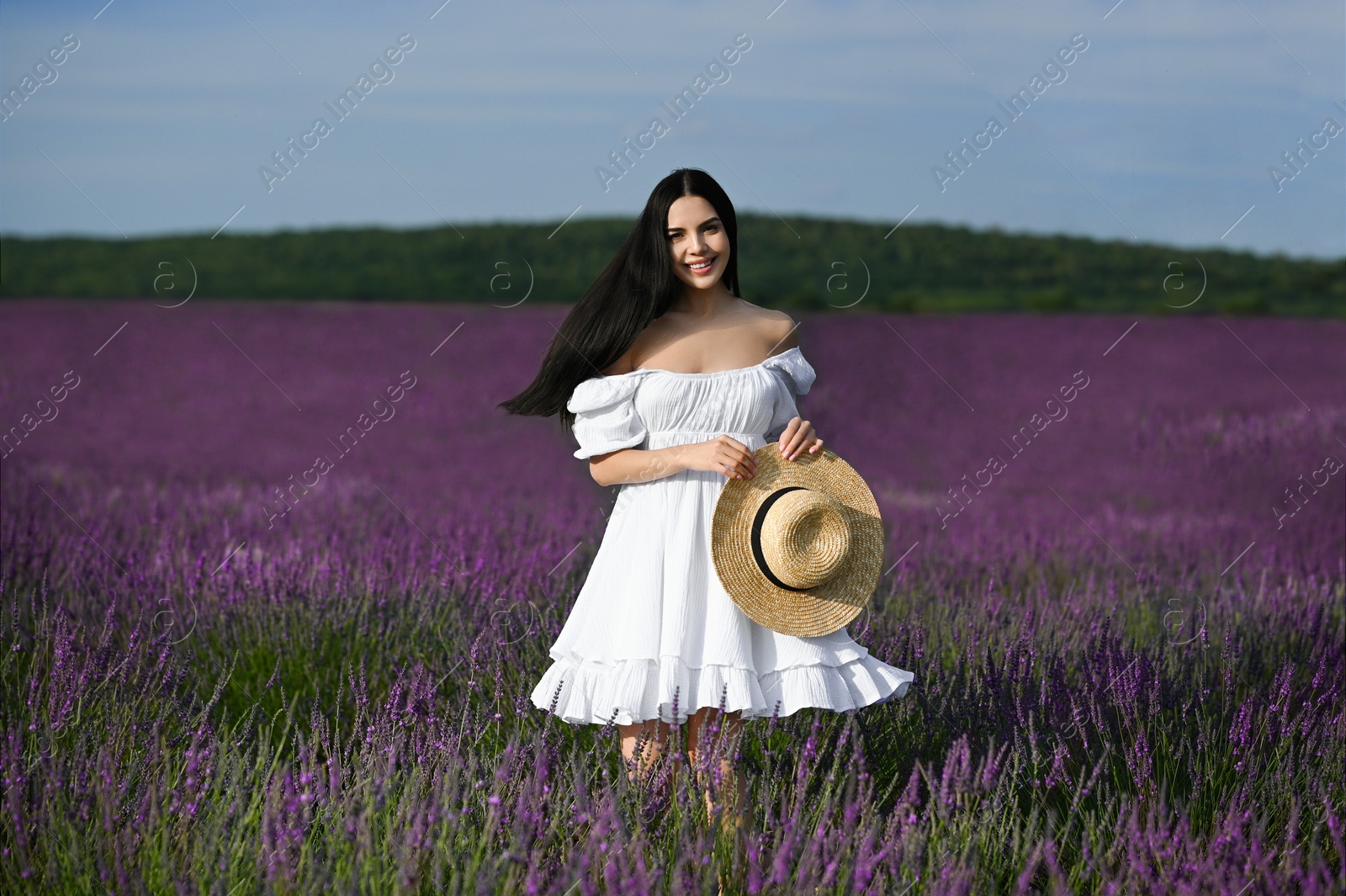 Photo of Beautiful young woman walking in lavender field