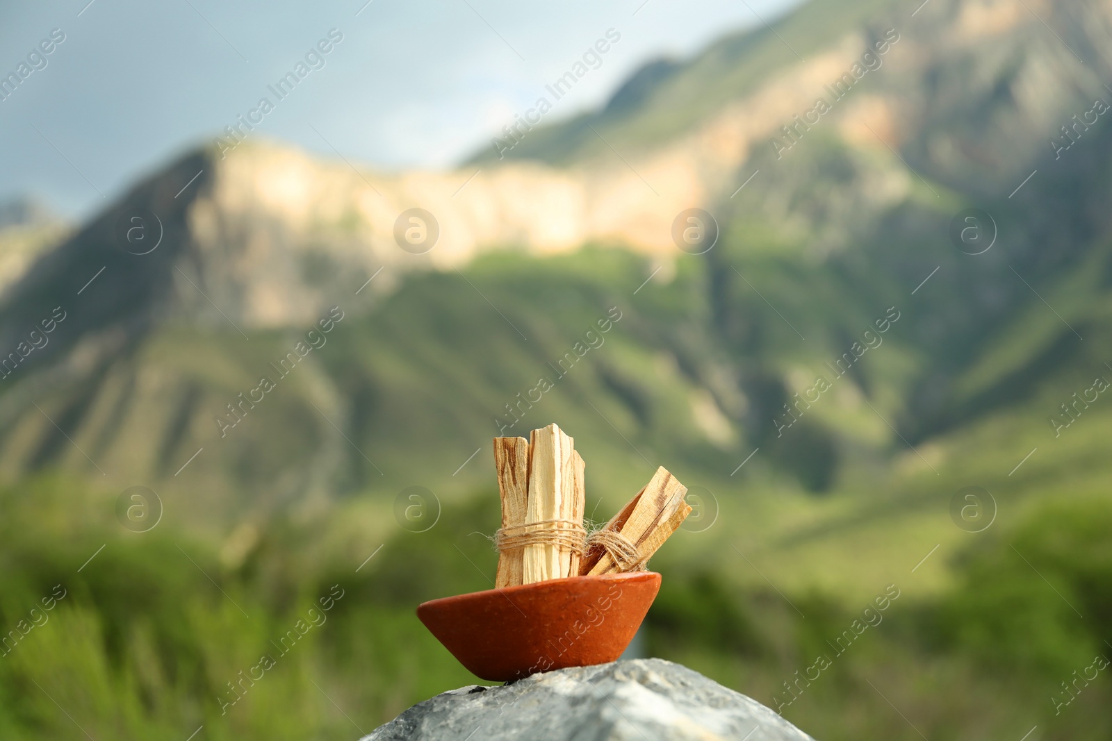 Photo of Many palo santo sticks on stone surface in high mountains