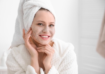 Photo of Woman with scrub on face in bathroom