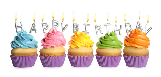 Birthday cupcakes with candles on white background