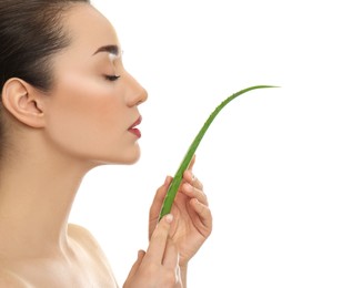 Young woman with aloe vera leaf on white background, closeup