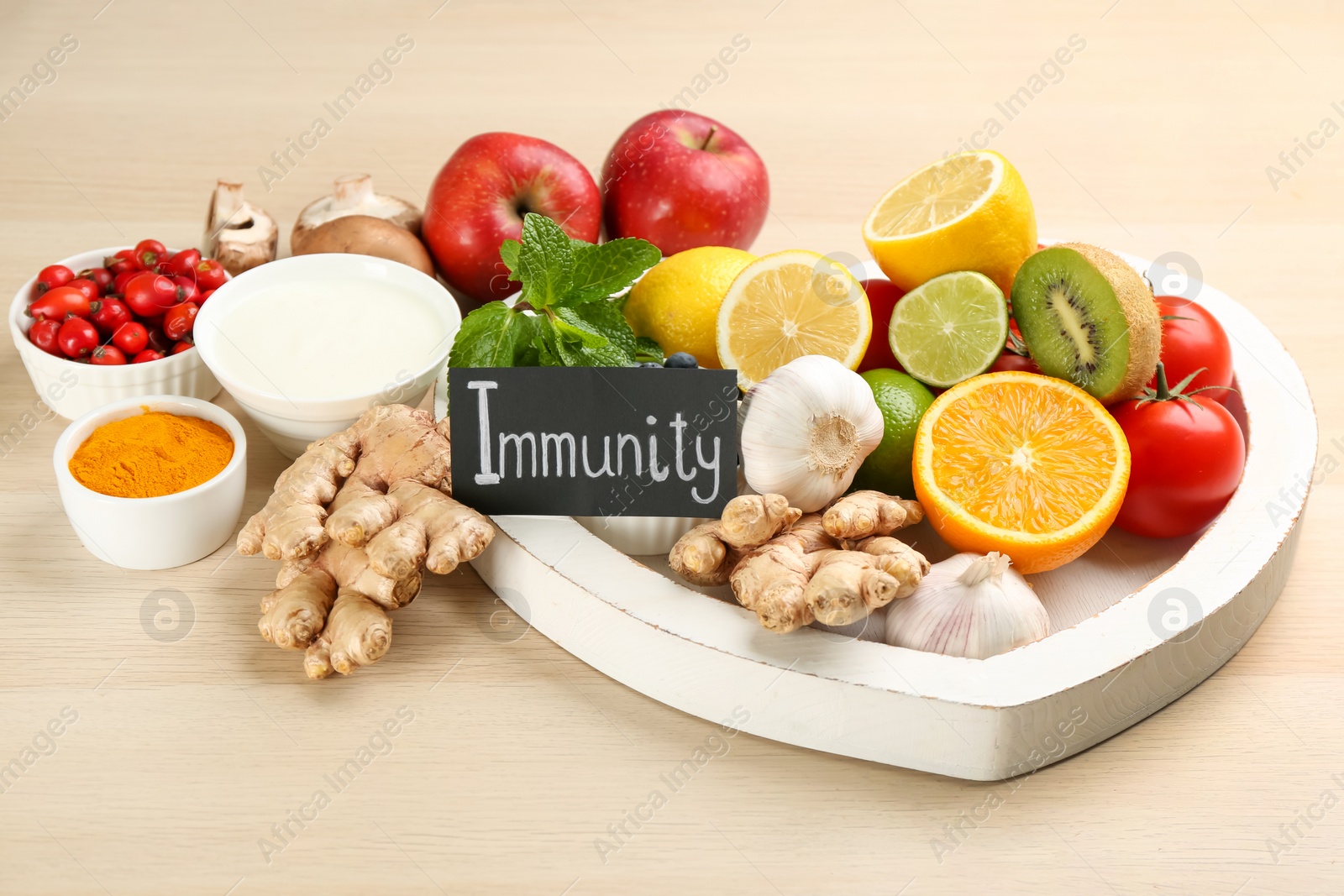 Photo of Card with word Immunity and fresh products on wooden table