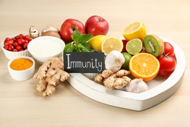 Card with word Immunity and fresh products on wooden table