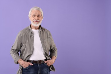 Portrait of stylish grandpa on purple background, space for text