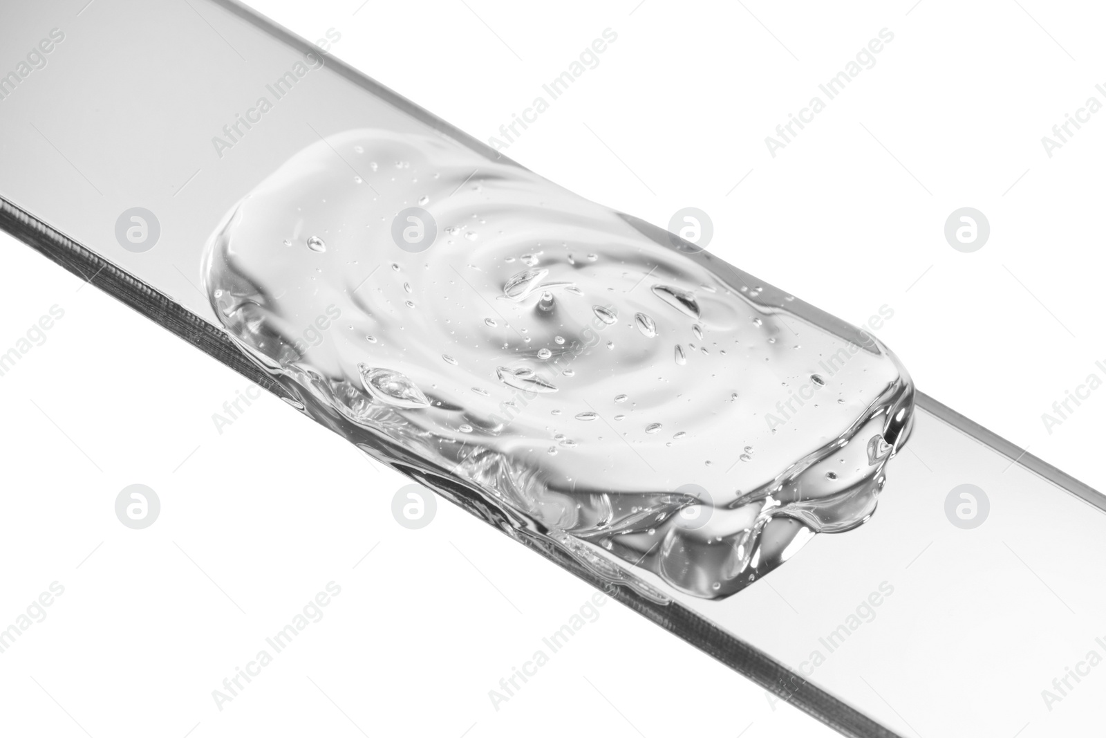 Photo of Glass slide with clear face gel on white background, closeup