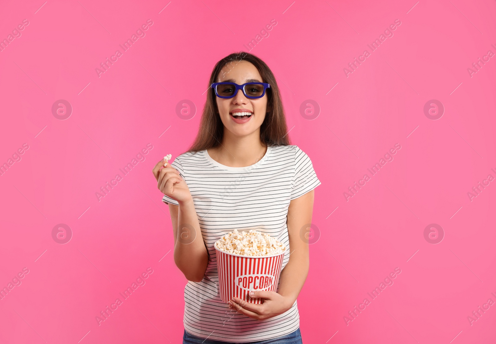 Photo of Woman with 3D glasses and popcorn during cinema show on color background