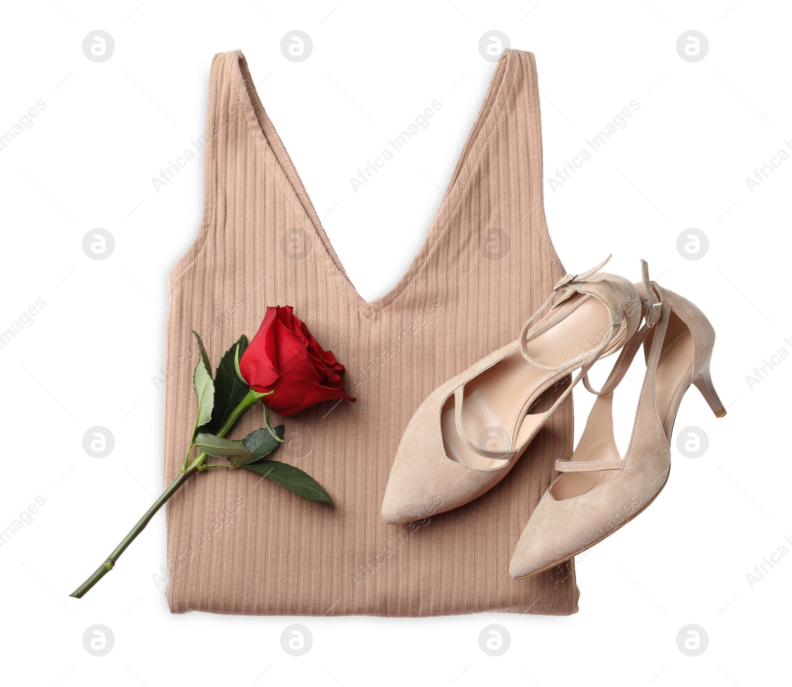 Photo of Folded dress, stylish high heeled shoes and flower on white background, top view