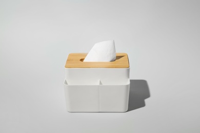 Photo of Holder with paper tissues on light grey background