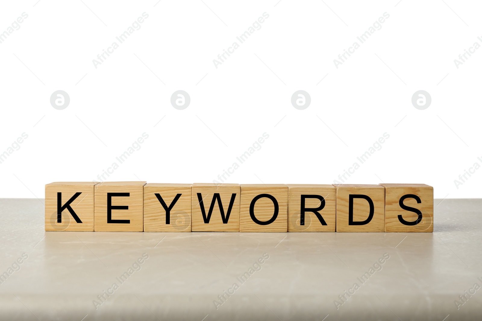 Photo of Wooden cubes with word KEYWORDS on light table