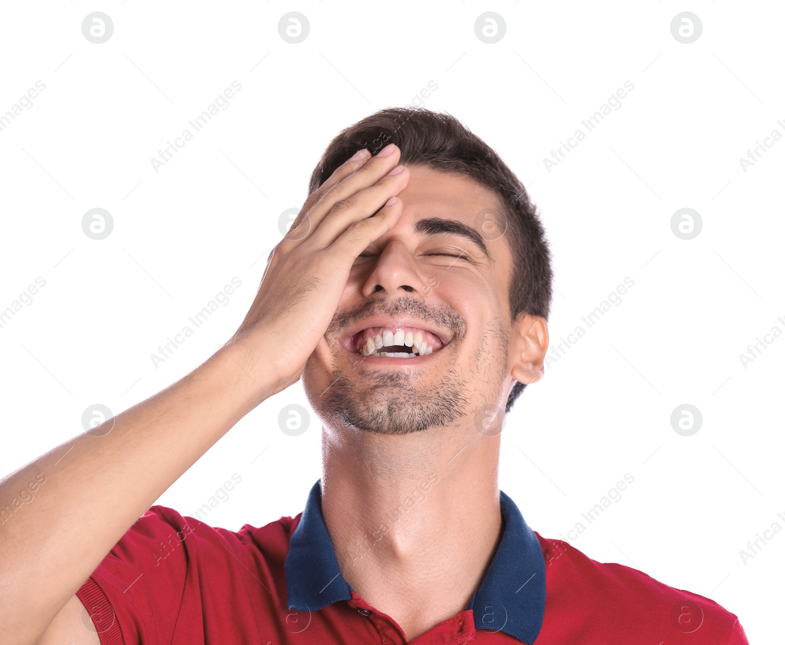 Photo of Portrait of handsome young man laughing on white background