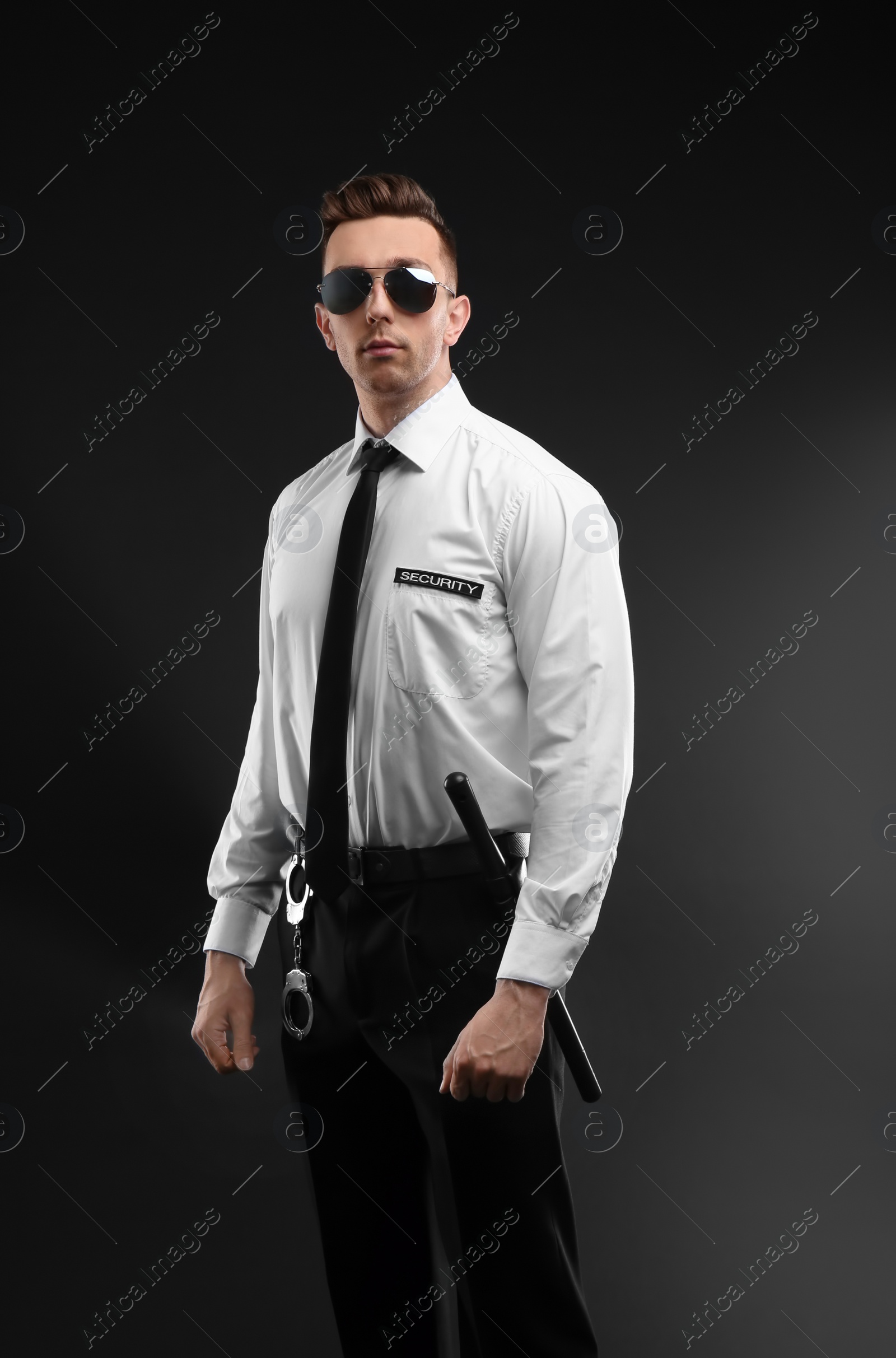 Photo of Male security guard in uniform on dark background