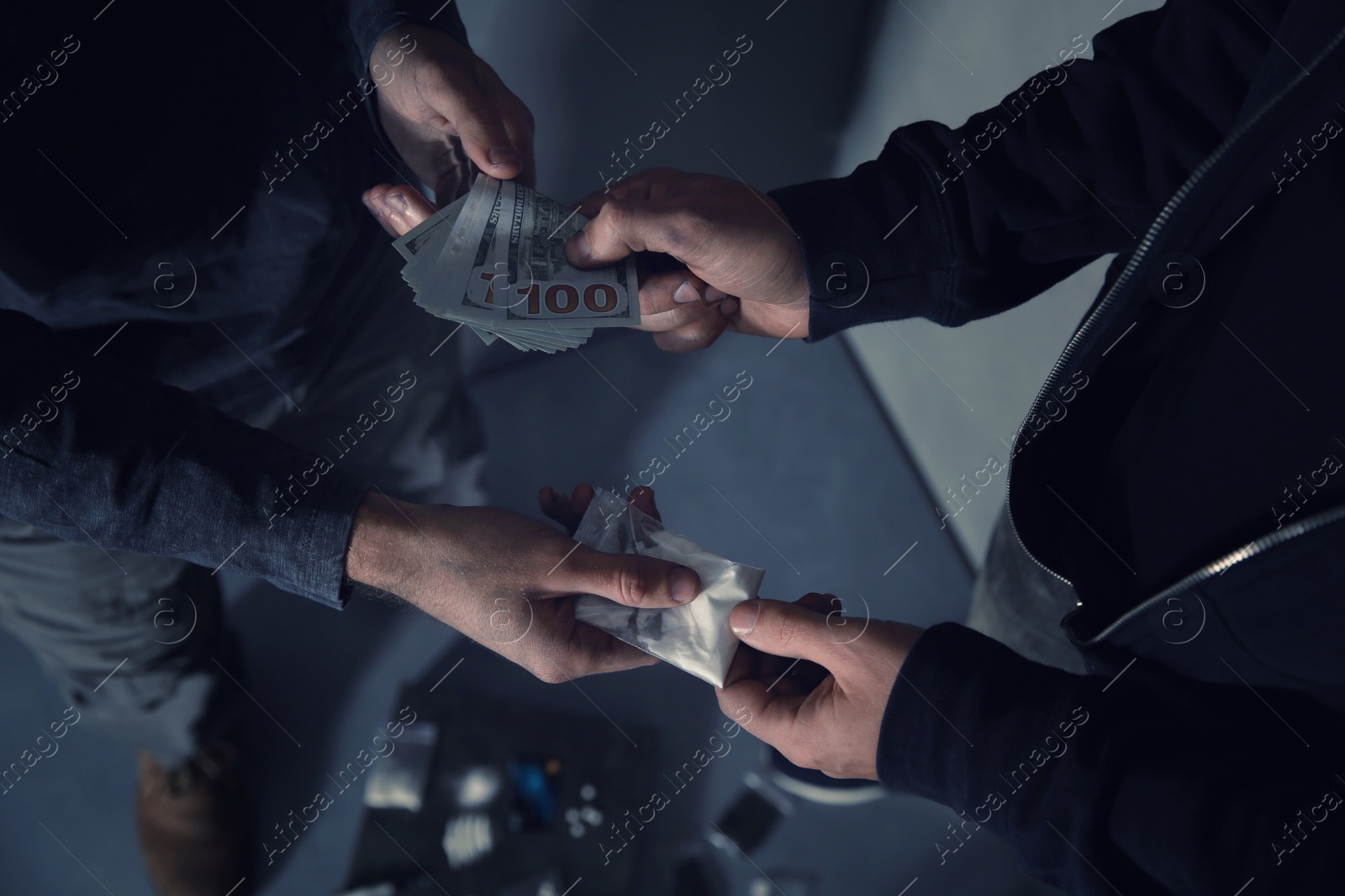 Photo of Addicted man buying drugs from dealer on blurred background, closeup