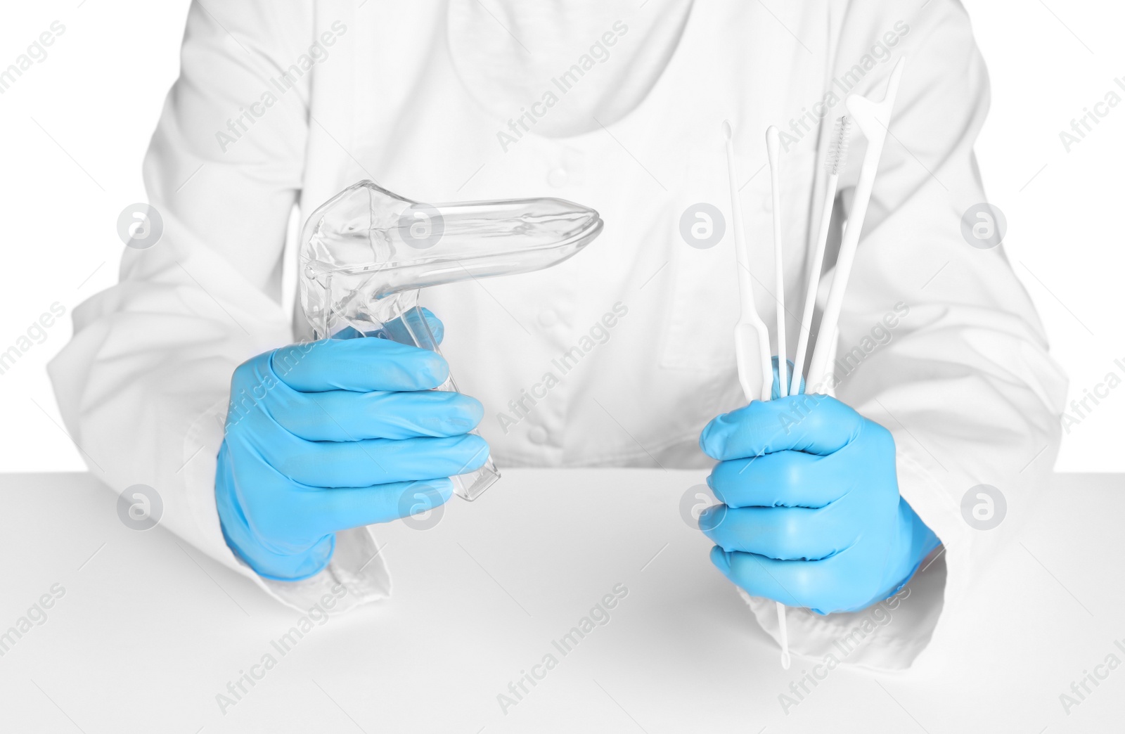 Photo of Doctor holding disposable vaginal speculum and gynecological examination kit on white background, closeup