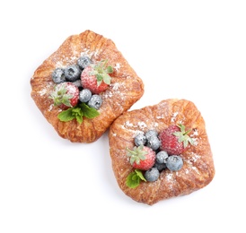 Fresh delicious puff pastry with sweet berries on white background, top view