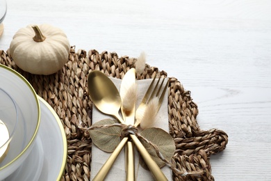 Autumn table setting and pumpkin on white wooden background, closeup