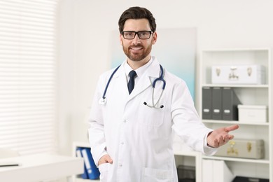 Photo of Medical consultant with glasses and stethoscope in clinic